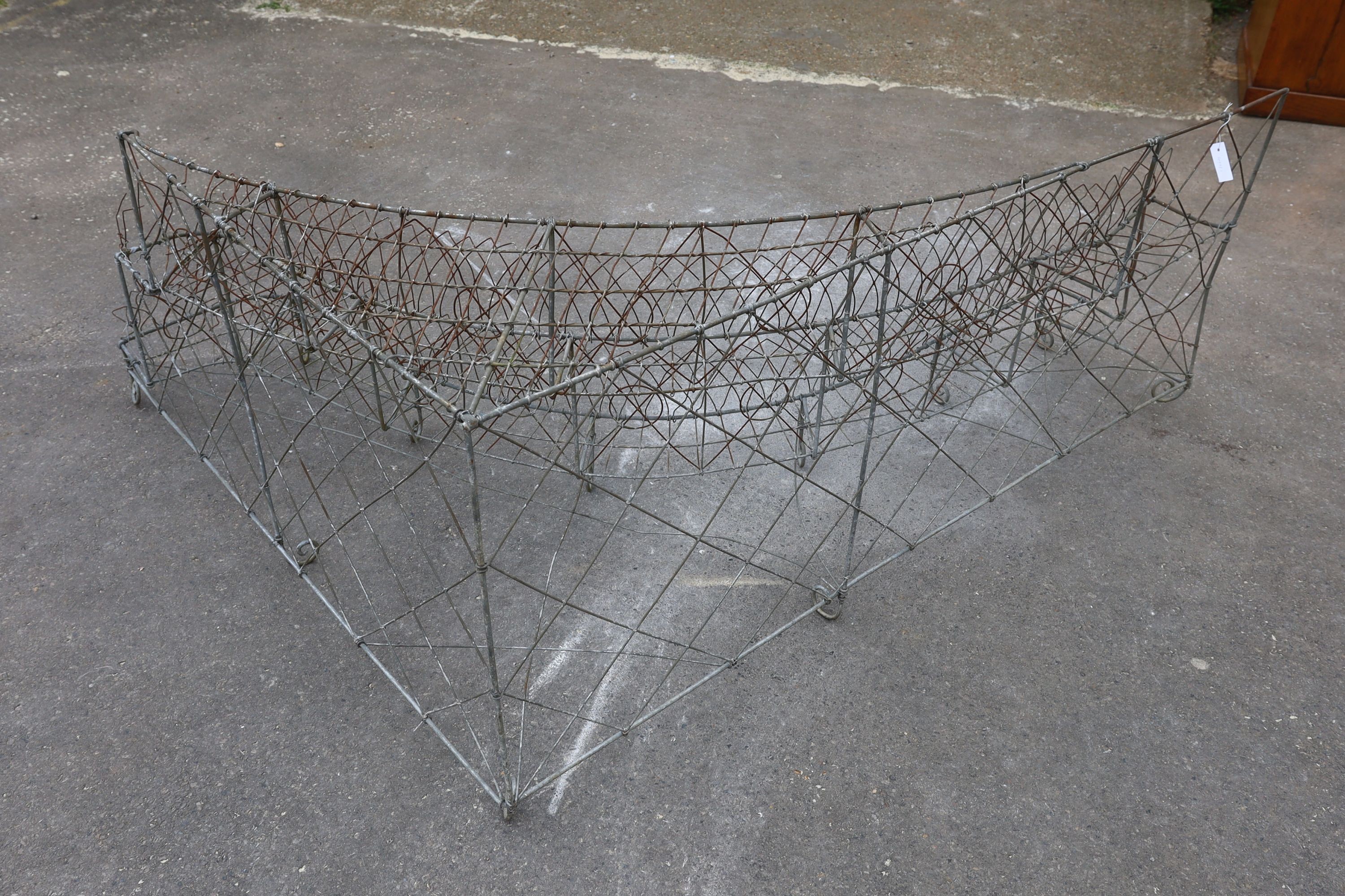 A wirework three tier corner pot stand, width 154cm, depth 180cm, height 68cm